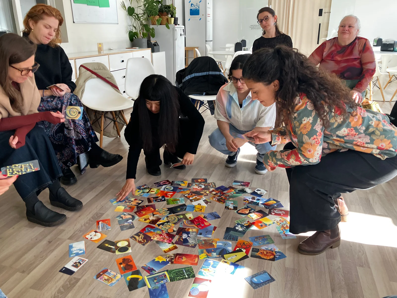 Participants exploring creative cards together at a Mental Bytes workshop