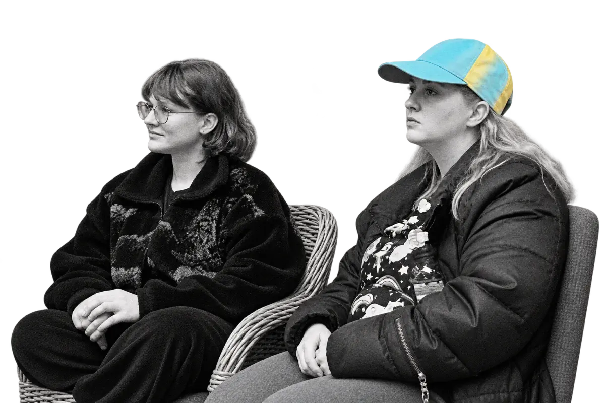 Two participants listening during the Mental Bytes IPS retreat, one in glasses and one wearing a colourful cap